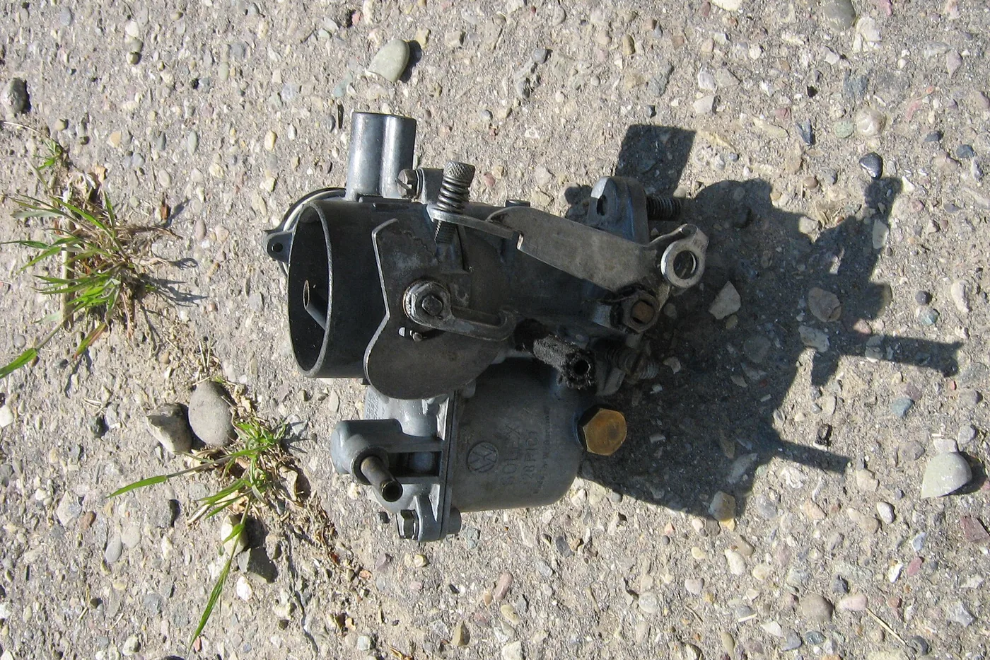 New-old-stock Volkswagen parts laid out in a grid, several still in their original boxes.